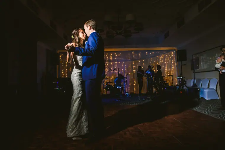 Elina and Iain's first dance in front of a fairy-light backdrop