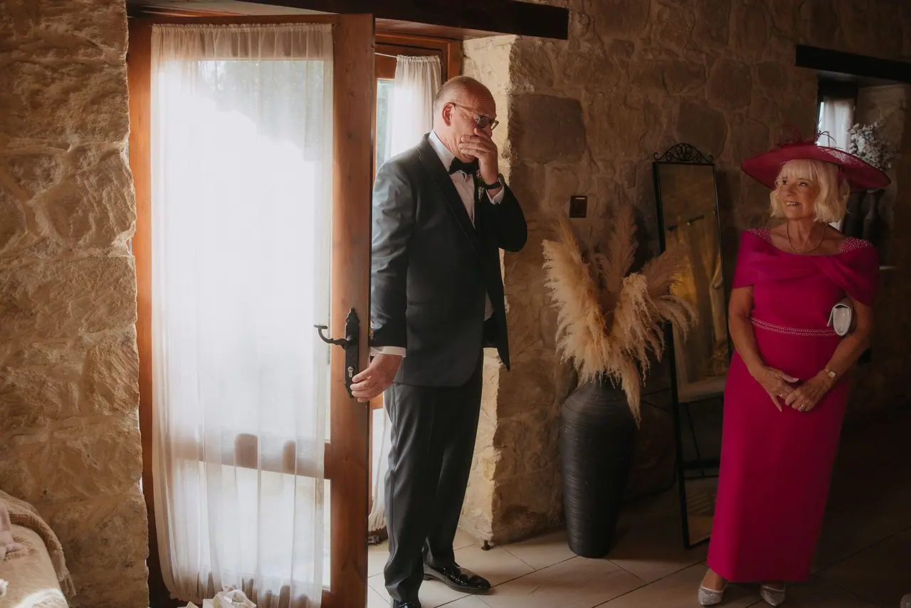 Zoe's dad pausing at the door of the bridal suite, hand to his face