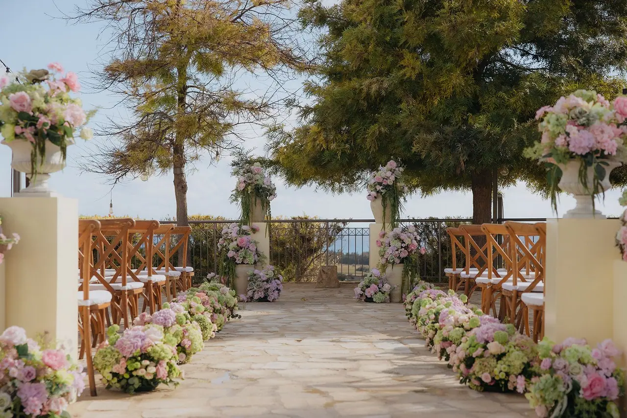 Flower-lined aisle on the Liopetro terrace leading towards the sea view
