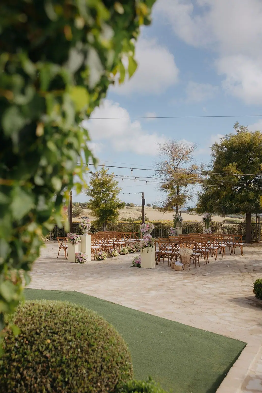 View through ivy to the ceremony set-up on the Liopetro terrace