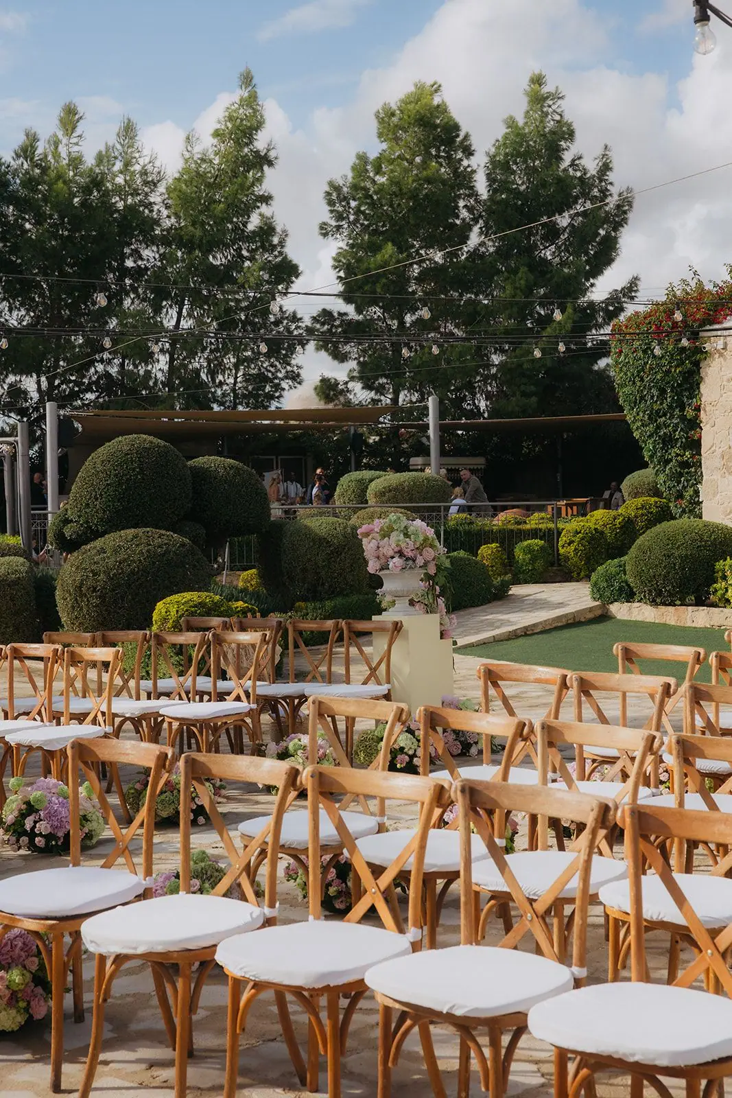 Wooden chairs set out in front of Liopetro's topiary gardens