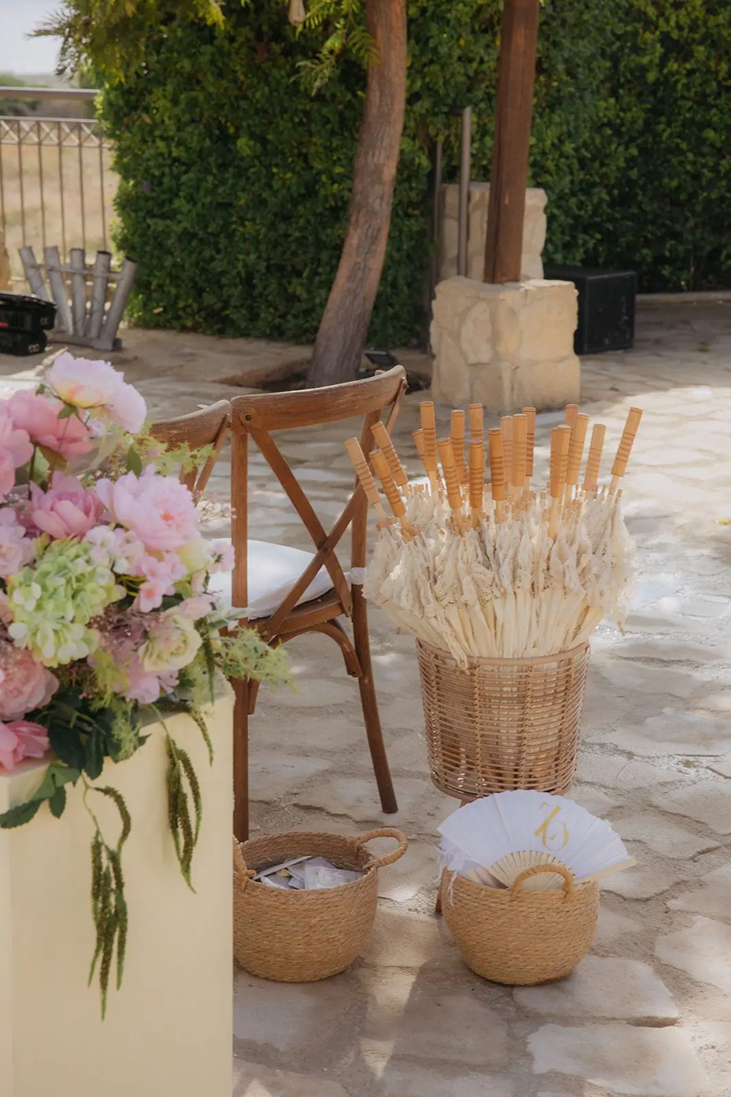 Baskets of dried wheat and paper fans for guests at the end of the rows