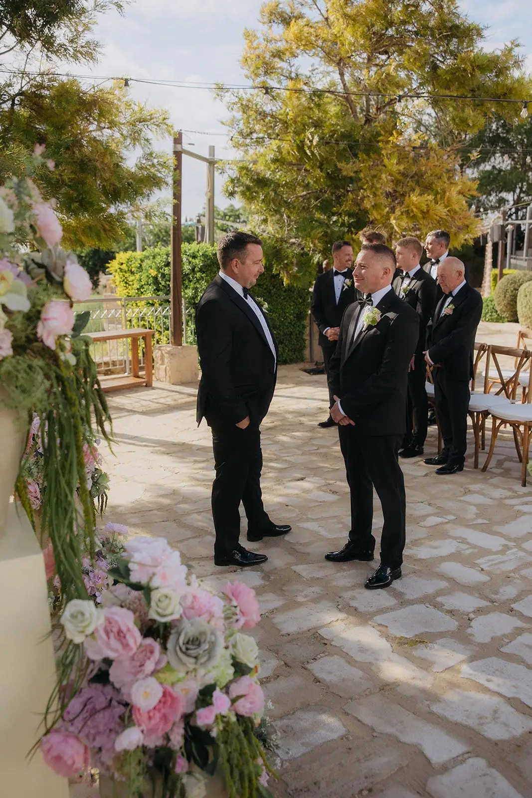 Oliver waiting at the front of the ceremony terrace with his groomsmen