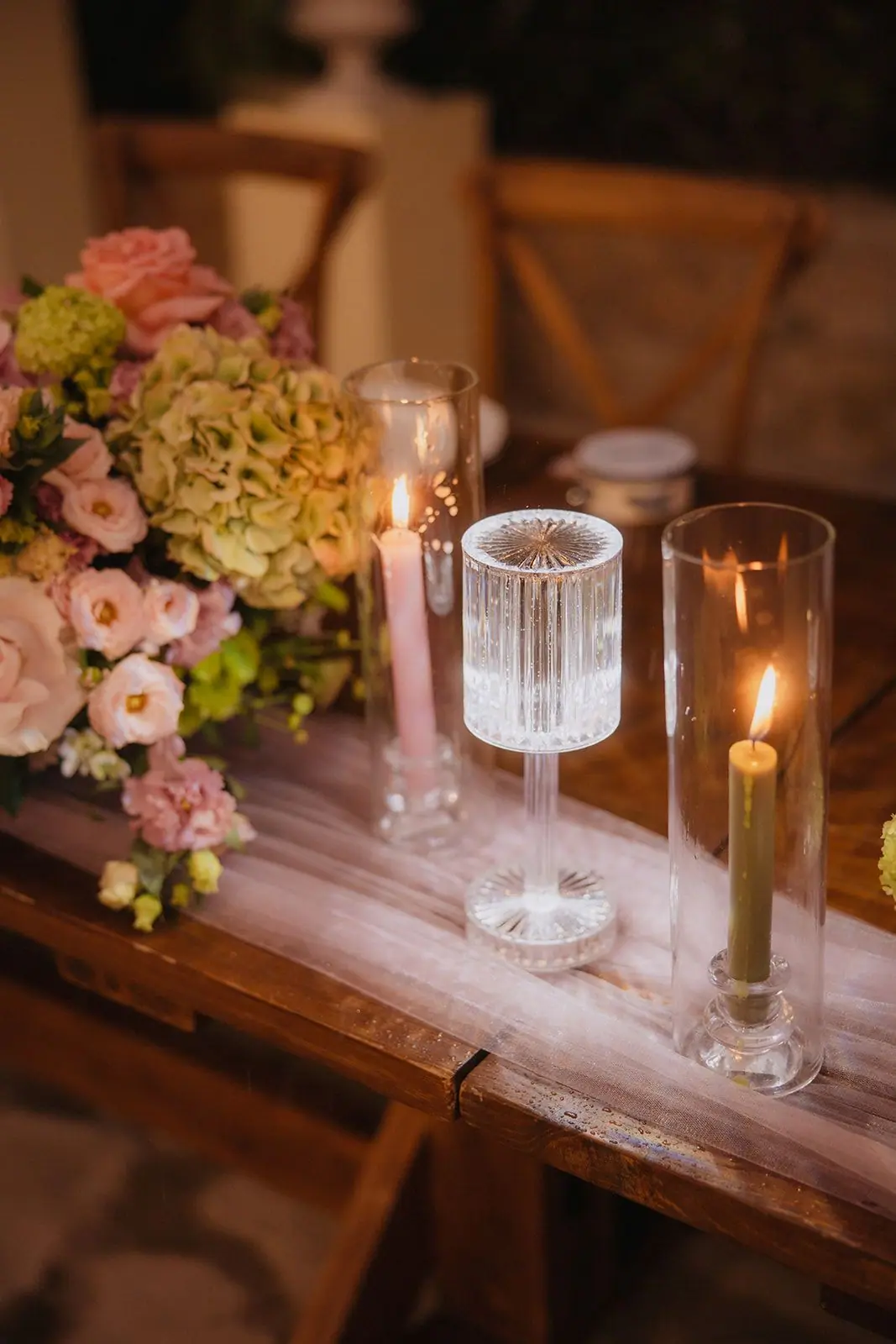 Pink and green flowers with candlelight on the reception table