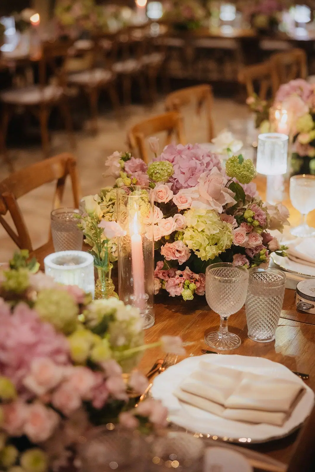 Close-up of a place setting with flowers and crystal glassware