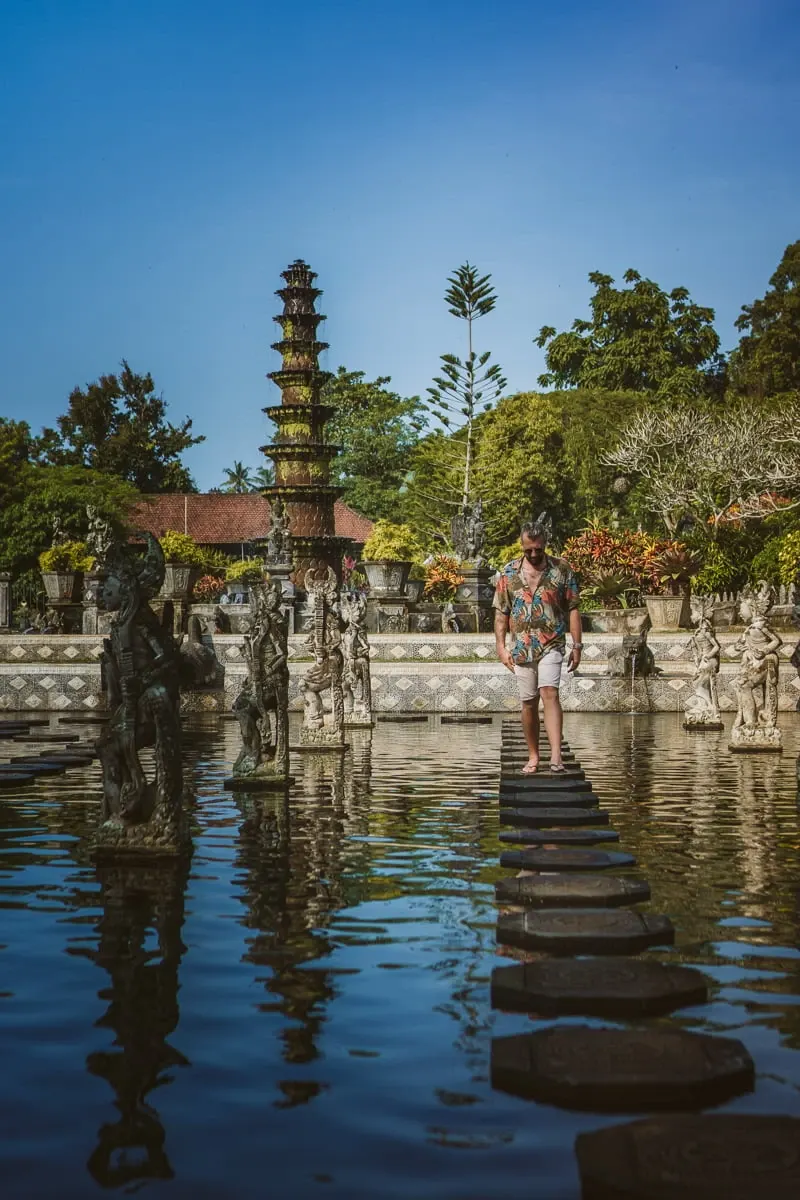 Stepping stones across a pond towards a tiered pagoda at a Balinese water garden