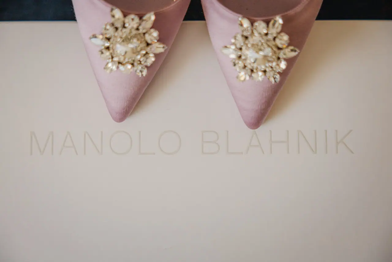 Pink Manolo Blahnik bridal shoes with jewelled buckles on their box, Alassos
