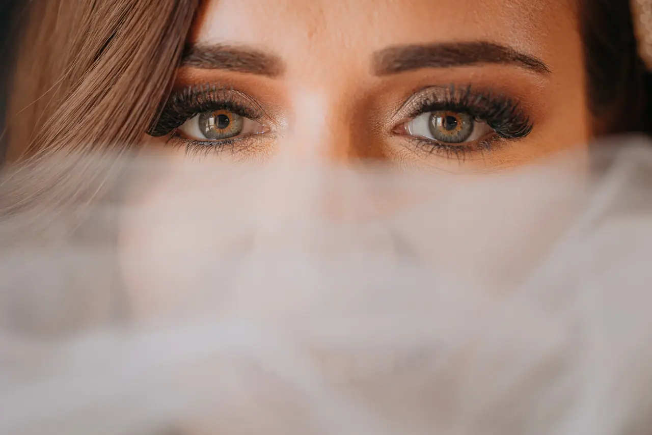 Close-up of the bride's green eyes above a soft veil