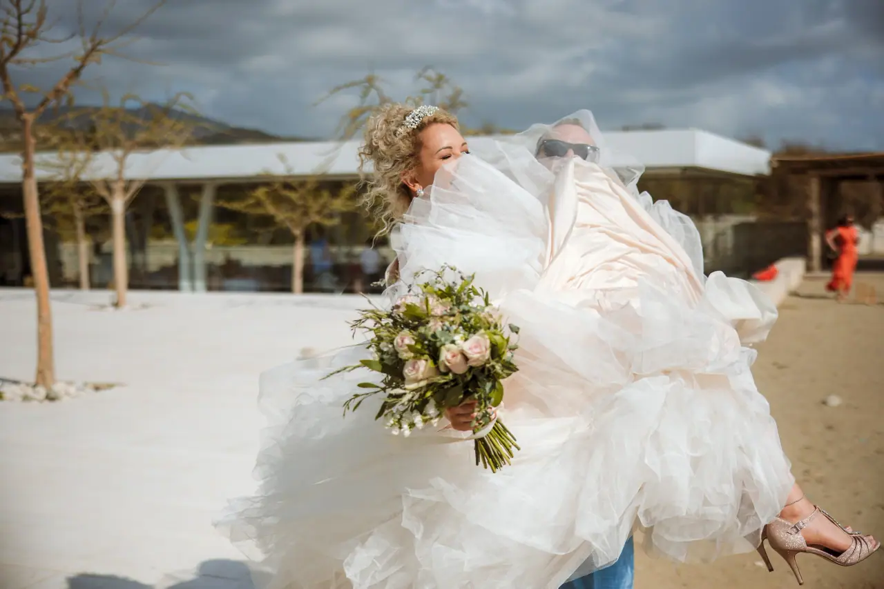 Debz's dress billowing as she twirls with her bouquet at Coral Residences