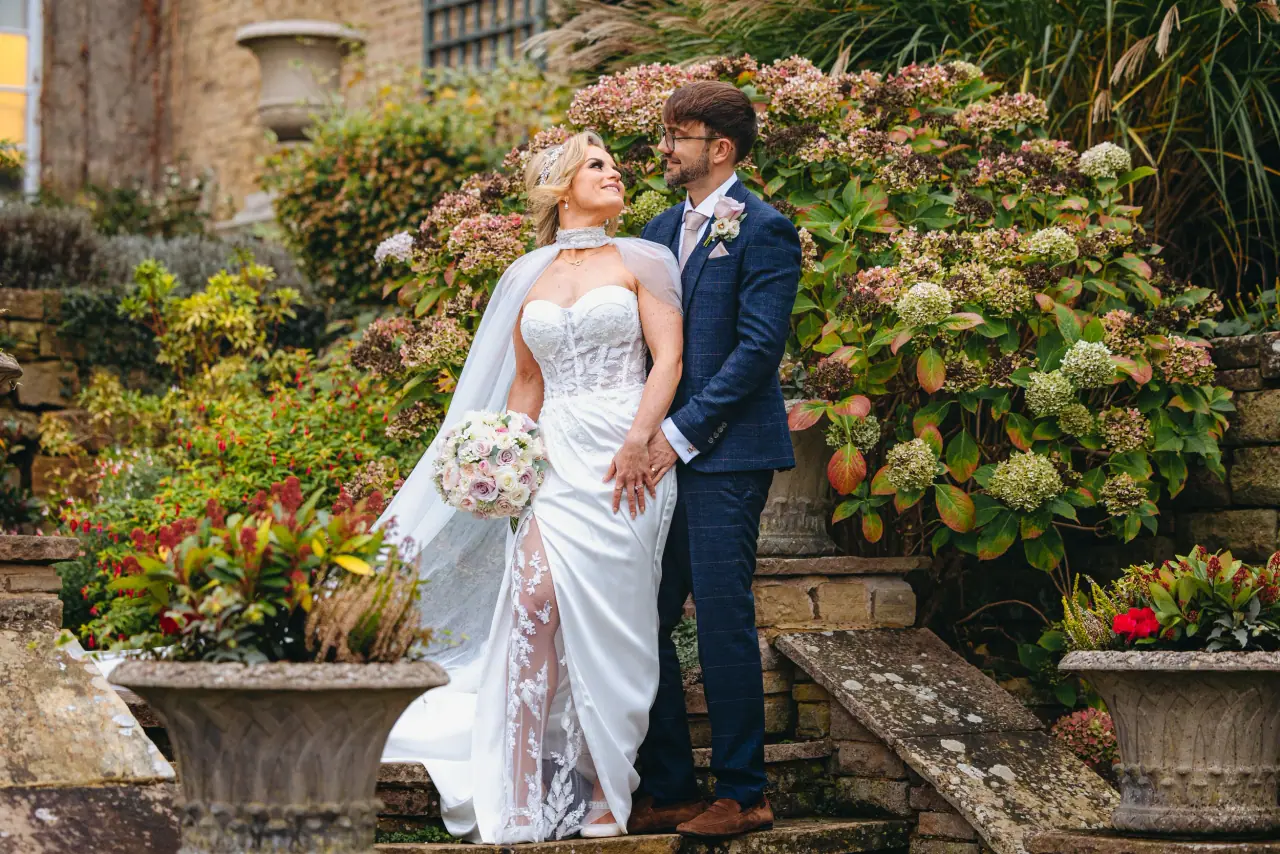Jade and Ian among hydrangeas on the garden steps at Hedsor House