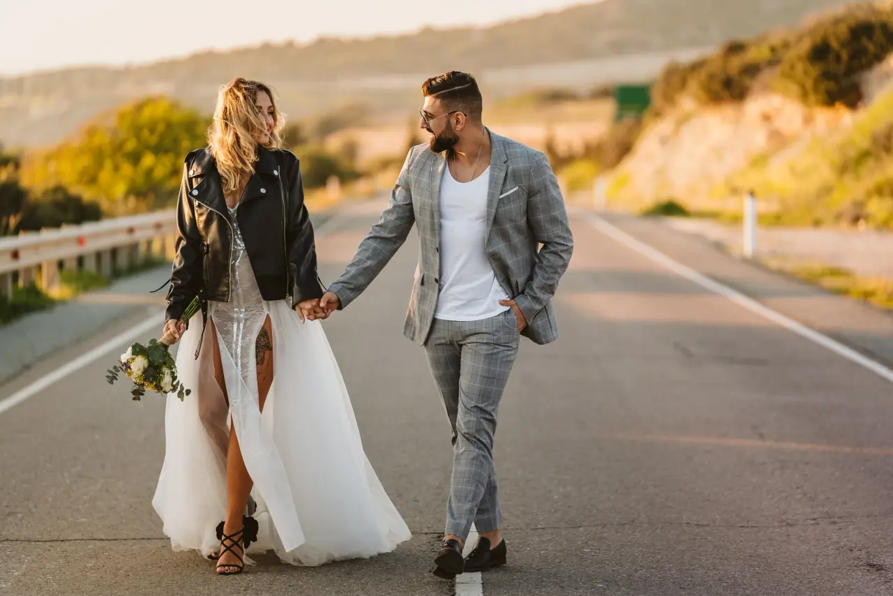 Julia and Taha walking hand in hand along an open road near Kouklia