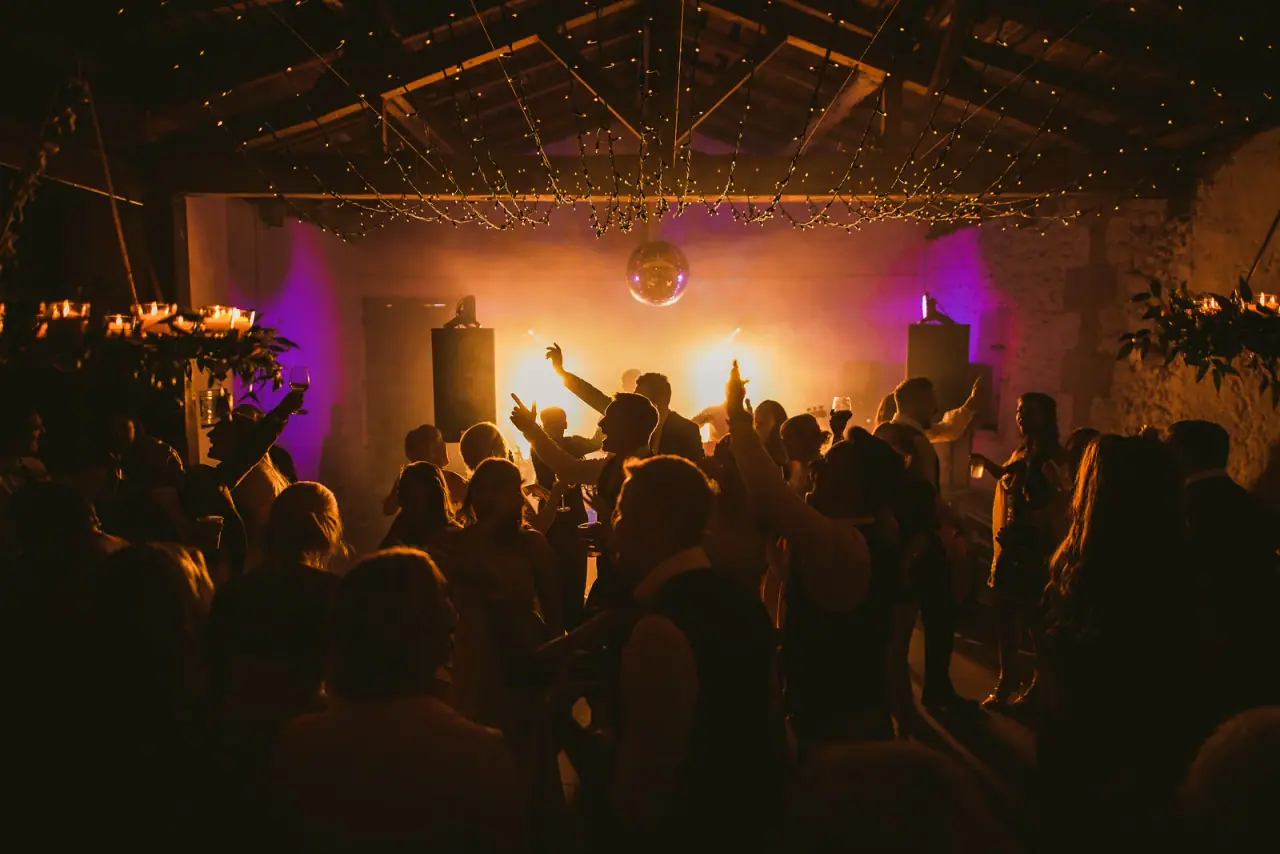 Guests dancing beneath purple stage lights at Raya and Adhib's reception, Ayia Napa