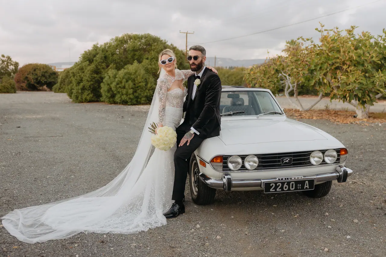 Bride and groom by the front of the 1977 Triumph Stag, Cyprus countryside
