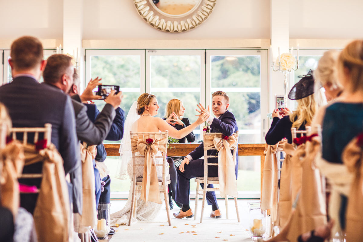 bride shows off grooms wedding ring