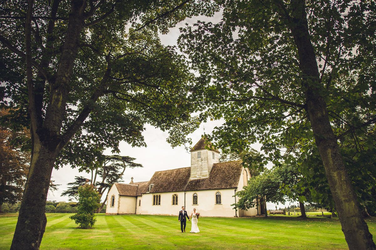 little chapel in field with couple