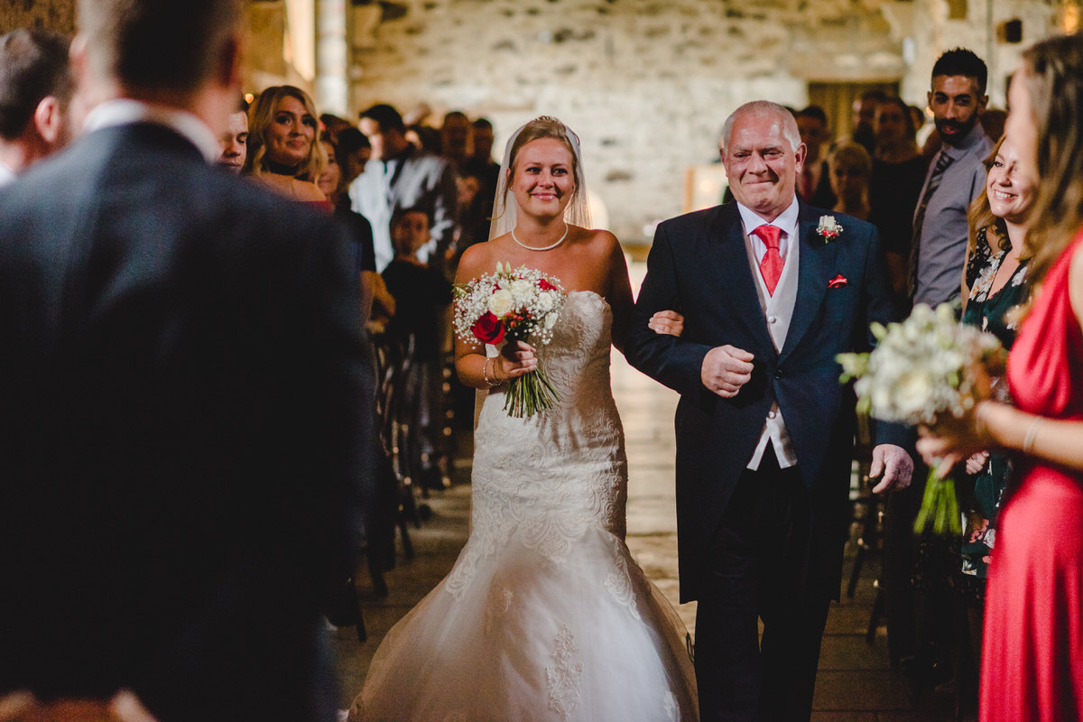 Father proudly walks his daughter down aisle