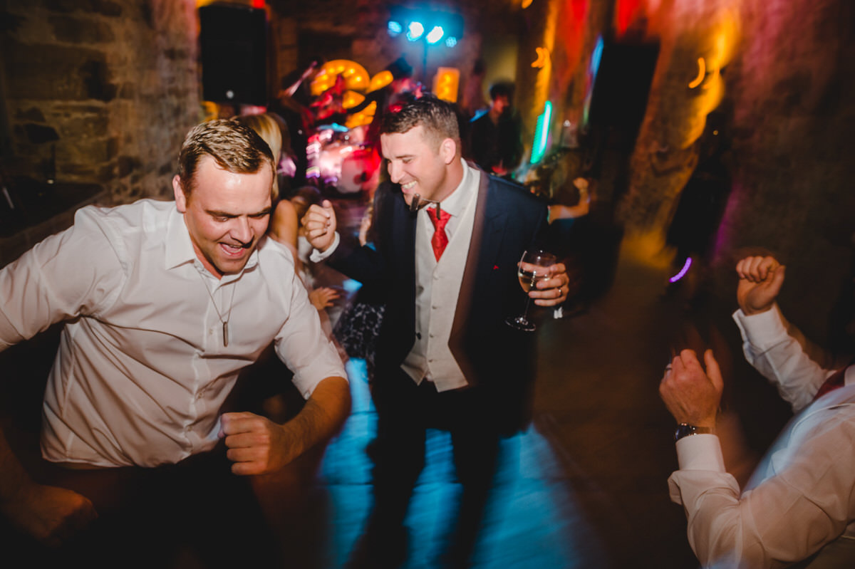 happy groom dancing at reception